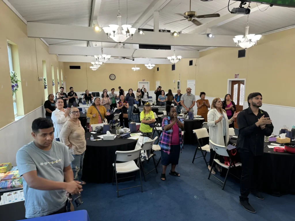 People in a church setting, singing and worshiping together.