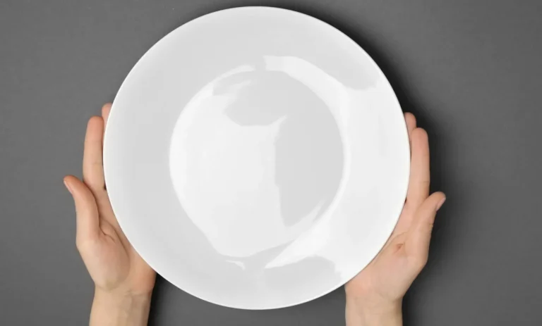 person holding an empty plate